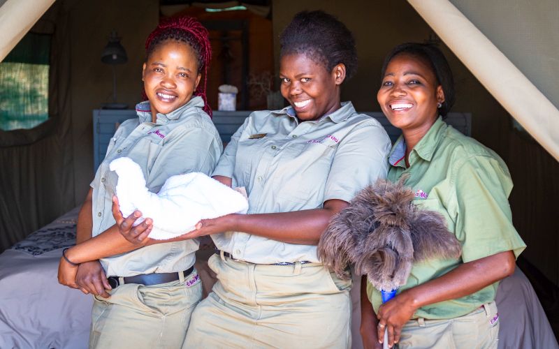 Staff members cleaning a room in one of the chalets in O Bona Moremi.