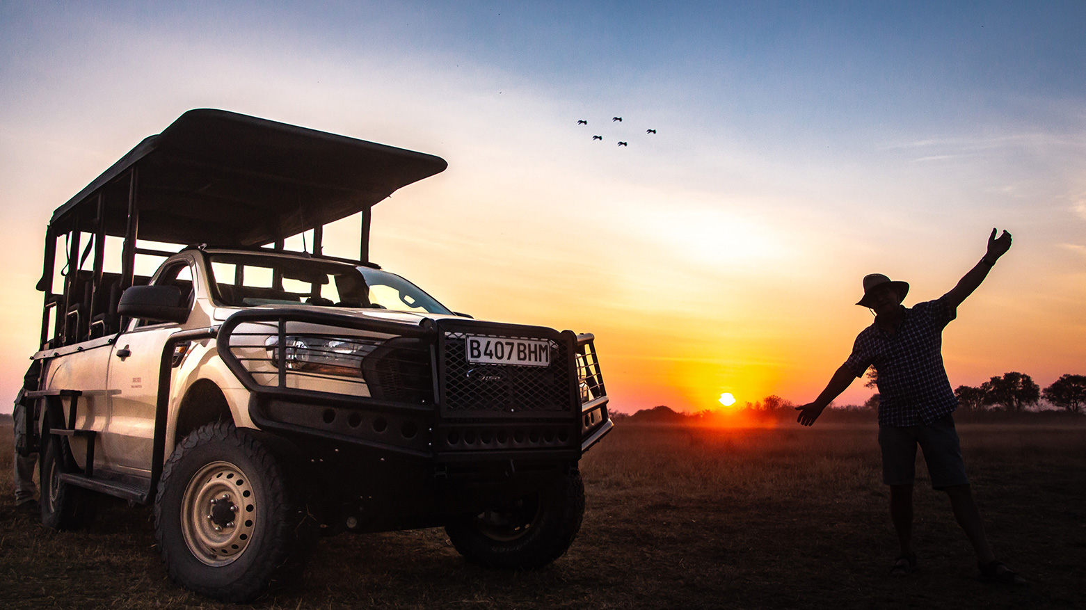 Open game viewing vehicle in the setting sun in Botswana